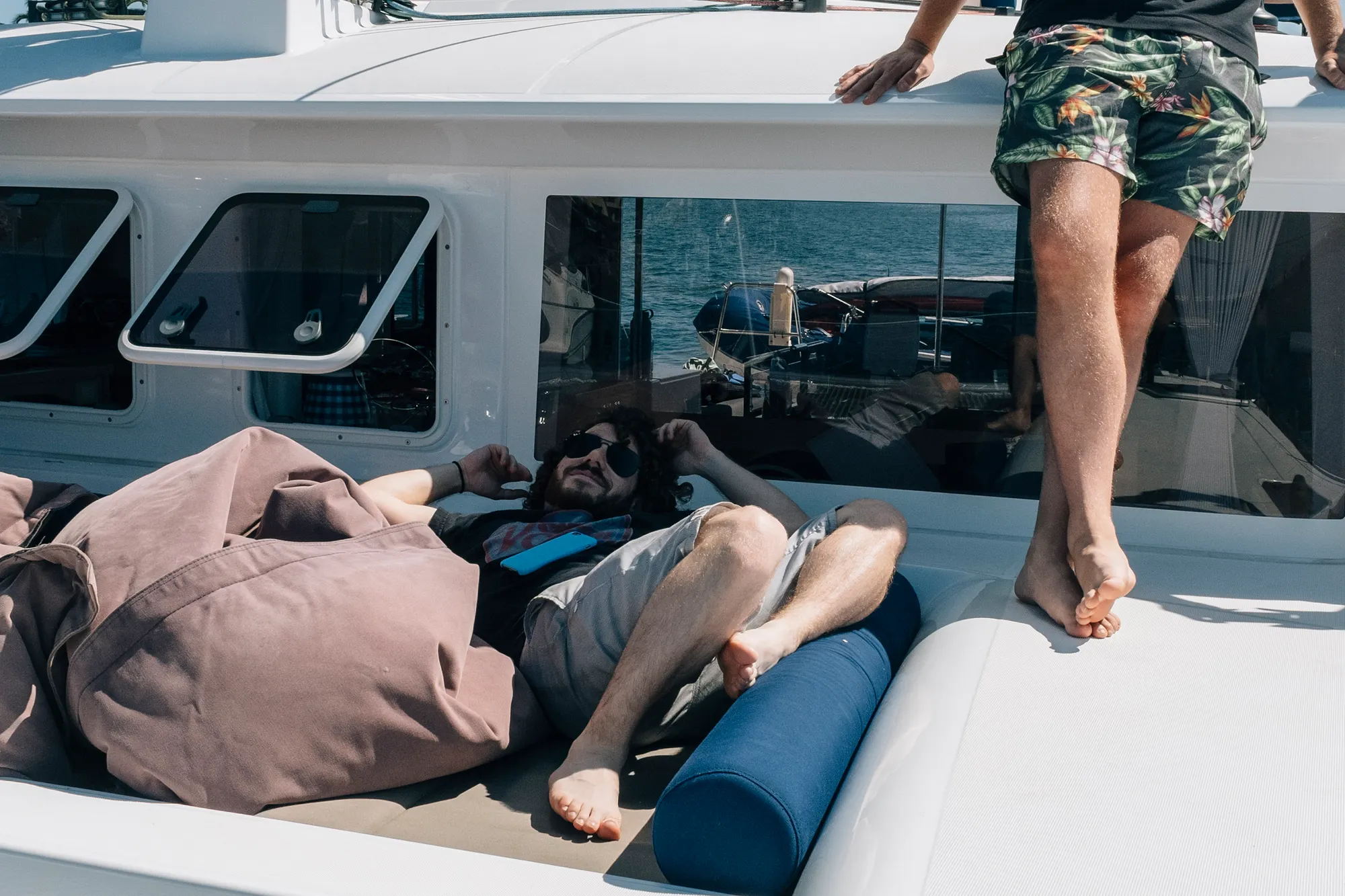 Joe hanging out at the front of the boat — I think he was the only one who managed to get some reading in.