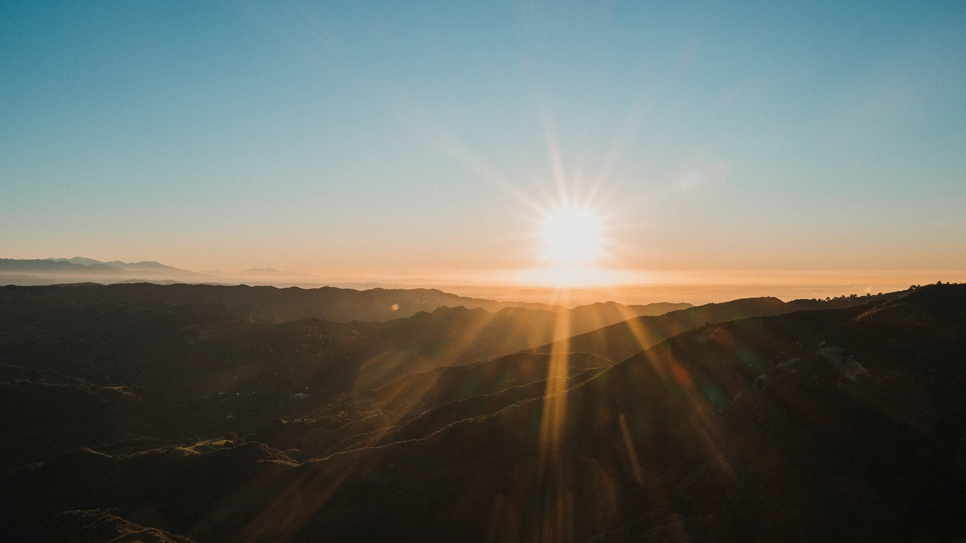 The sun clearing the ridgeline